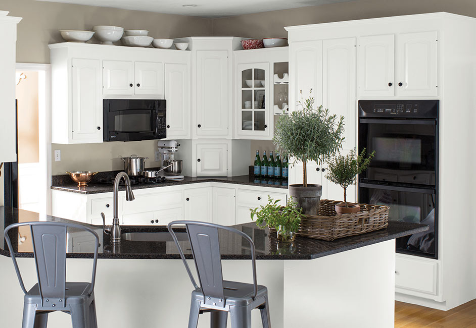 A before and after of the same kitchen features an all-white makeover using ADVANCE® Interior Paint.