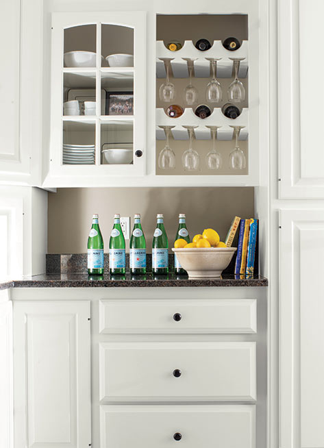 A before and after of a built-in wine rack, glass-paneled cabinet and kitchen drawers showcase an al