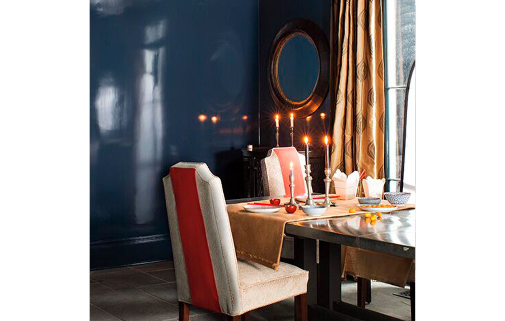 Comedor con paredes de color azul brillante con una mesa de comedor con sillas detalles en naranja