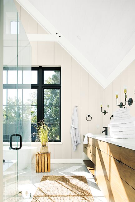 Un baño amplio y luminoso pintado en colores neutros y blancos.